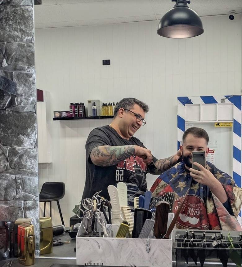 Barber and client sharing a laugh mid-cut at Big Boy Barber